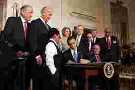 https://kpfa.org/app/uploads/2025/12/Obama-signs-ACA-1.jpg
